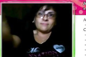 Fat granny sits in front of the web camera and rubs her fanny