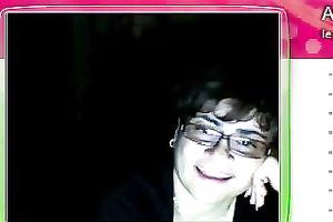 Fat granny sits in front of the web camera and rubs her fanny