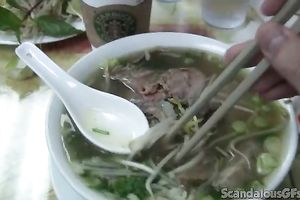 Pale skin brunette hair chick eats noodle soup on livecam