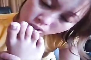 Insane Asian wench enjoys licking her own feet on web camera