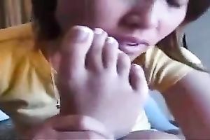 Insane Asian wench enjoys licking her own feet on web camera