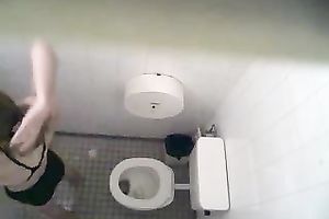 Spy clip from a swimming pool water closet - chick takes a piddle
