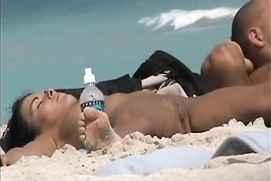 Beautiful dark brown youthful sweetheart on the beach feels nice