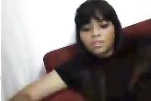 Black sweetheart rubs her fanny in bedroom throughout her pants