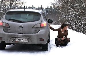 Beautiful slim auburn haired playgirl urinates behind the car