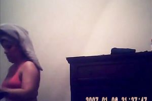 Hidden camera of lustful bulky dark brown putting on her raiment after shower