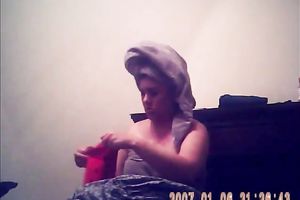 Hidden camera of lustful bulky dark brown putting on her raiment after shower