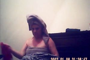 Hidden camera of lustful bulky dark brown putting on her raiment after shower