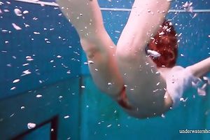 Cute and hawt Russian redhead legal age teenager filmed undressed in the pool underwater