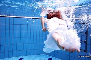 Cute and hawt Russian redhead legal age teenager filmed undressed in the pool underwater
