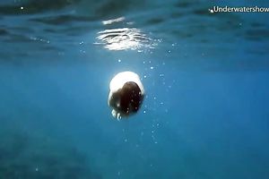 Cute redhead legal age teenager sweetheart in the open blue sea underwater