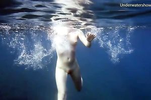 Cute redhead legal age teenager sweetheart in the open blue sea underwater