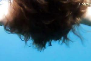 Cute redhead legal age teenager sweetheart in the open blue sea underwater