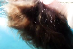 Cute redhead legal age teenager sweetheart in the open blue sea underwater