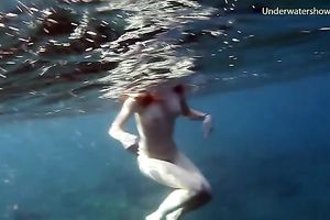 Cute redhead legal age teenager sweetheart in the open blue sea underwater