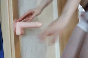 Nasty and lustful whore masturbating passionately with attachable marital-device