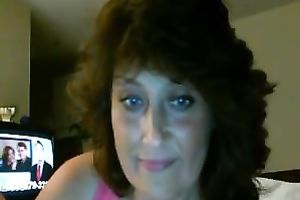 Chubby older brunette masturbates in front of a livecam