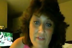 Chubby older brunette masturbates in front of a livecam