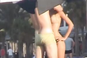 Sweet lean dark brown honey topless on the beach getting groped