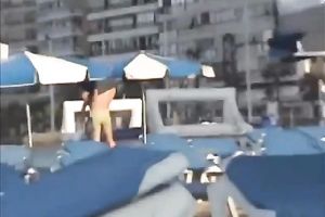 Sweet lean dark brown honey topless on the beach getting groped