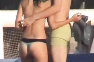 Sweet lean dark brown honey topless on the beach getting groped