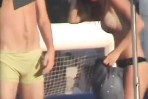 Sweet lean dark brown honey topless on the beach getting groped
