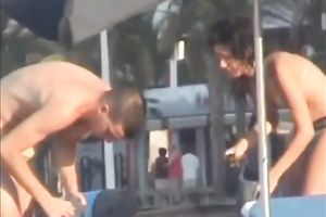 Sweet lean dark brown honey topless on the beach getting groped