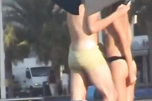 Sweet lean dark brown honey topless on the beach getting groped