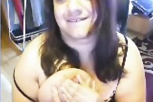 Ugly as fuck web camera doxy plays with her actually massive boobies