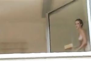 Magnificent and breasty blond honey washed the windows topless
