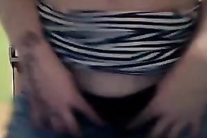 Foureyed older woman stripping in the kitchen