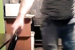 Foureyed older woman stripping in the kitchen