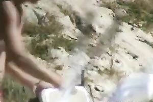 Amateur white lady sitting on the rocks spied with camera