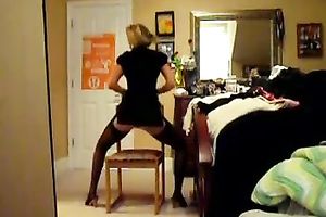 Alluring blond playgirl dances striptease in red underware and nylons