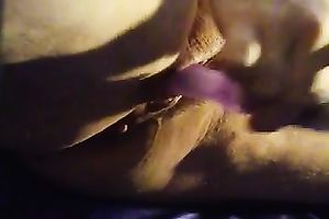 Mature slutwife masturbating with a diminutive purple toy and squirting