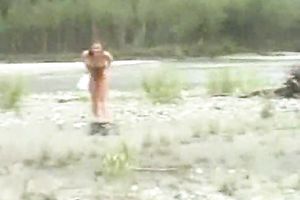 Curvaceous redhead girlfriend exposes her body over the river shore