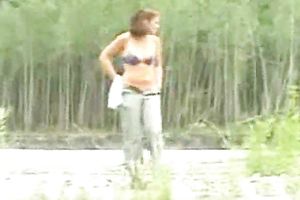 Curvaceous redhead girlfriend exposes her body over the river shore