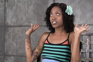 Playful and happy dark housewife gagged and chained on the wooden box