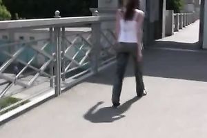 Redhead slut pees in her pants on a bridge in void urine fetish solo
