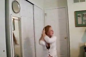 Skanky redhead gives non-professional striptease show on the livecam