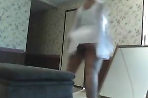 Curvaceous brown skin girlfriend in white costume on webcam