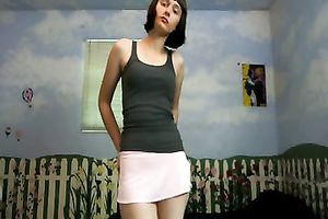 Amateur brunette hair wearing a miniskirt shows her cleavage for the webcam