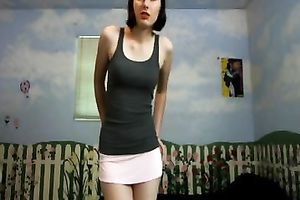 Amateur brunette hair wearing a miniskirt shows her cleavage for the webcam