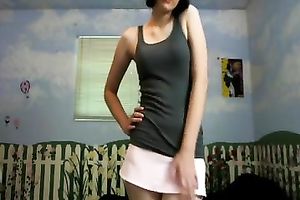 Amateur brunette hair wearing a miniskirt shows her cleavage for the webcam