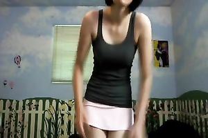 Amateur brunette hair wearing a miniskirt shows her cleavage for the webcam