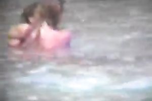 Sexy pair of blonde people getting horny and cuddly on the beach