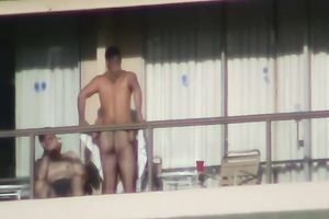 Spy clip of beefy muscular guy fucking excited black cock sluts on a balcony