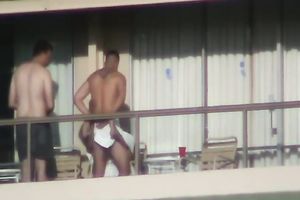 Spy clip of beefy muscular guy fucking excited black cock sluts on a balcony