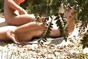 Beautiful bare floozy rides her mate on the beach - spy movie scene