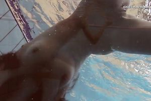 Beautiful brunette hair white white wife beneath water in the pool